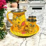 Stainless steel pitcher set includes a sleek pitcher, matching tumblers, and a round tray, designed for everyday use.